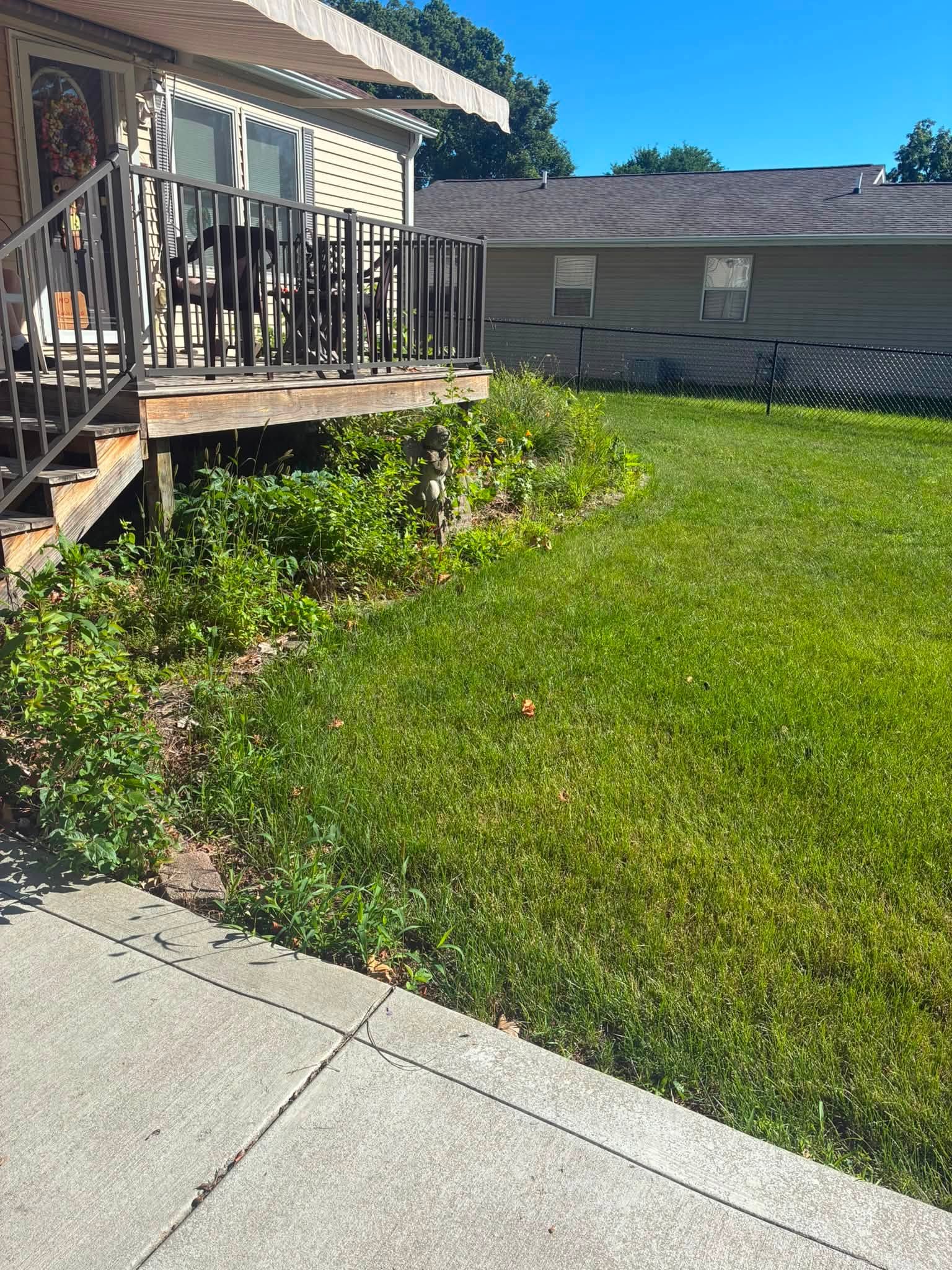 Before: overgrown planting bed beside a front porch
