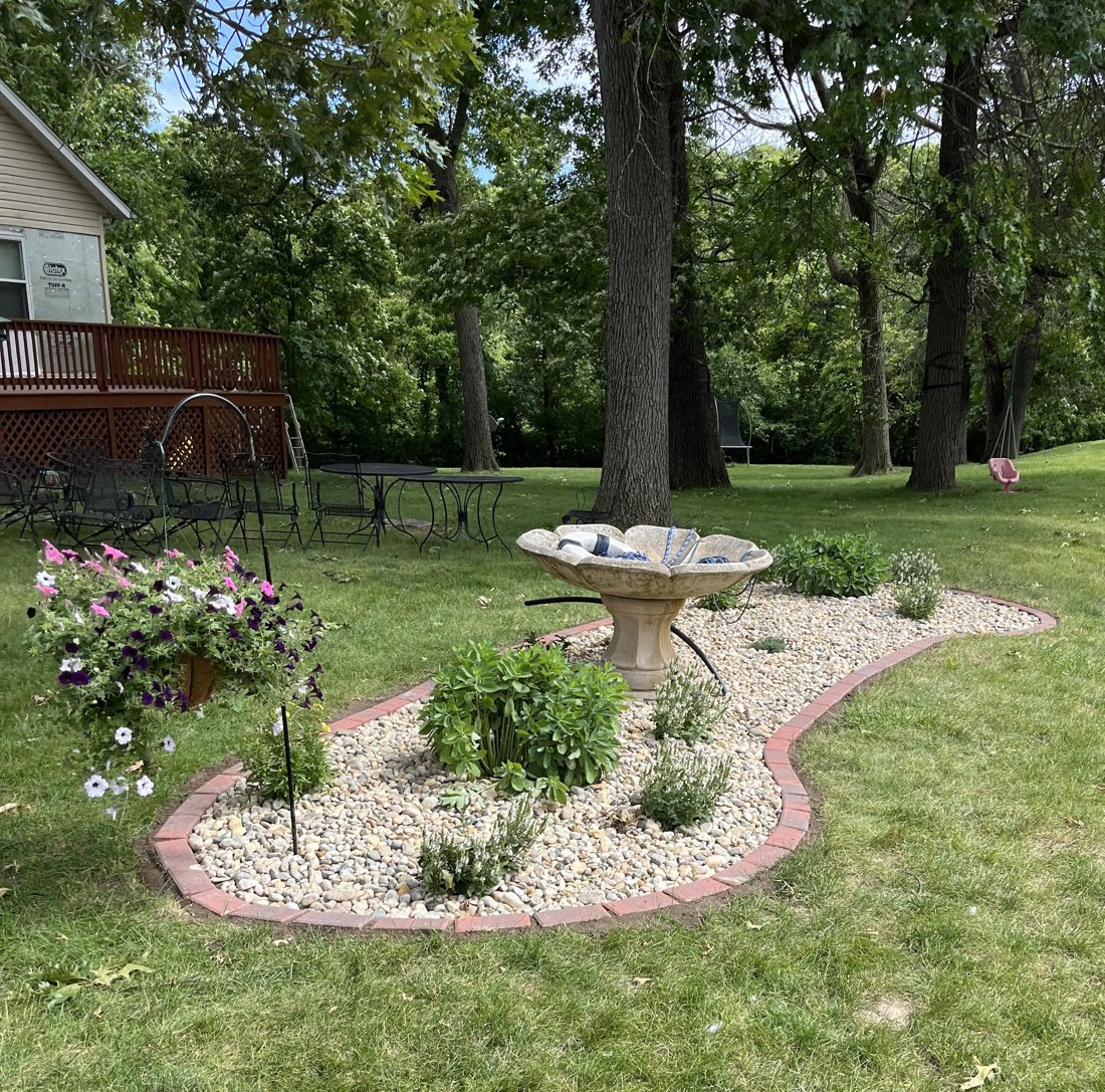 Stone garden bed around a birdbath